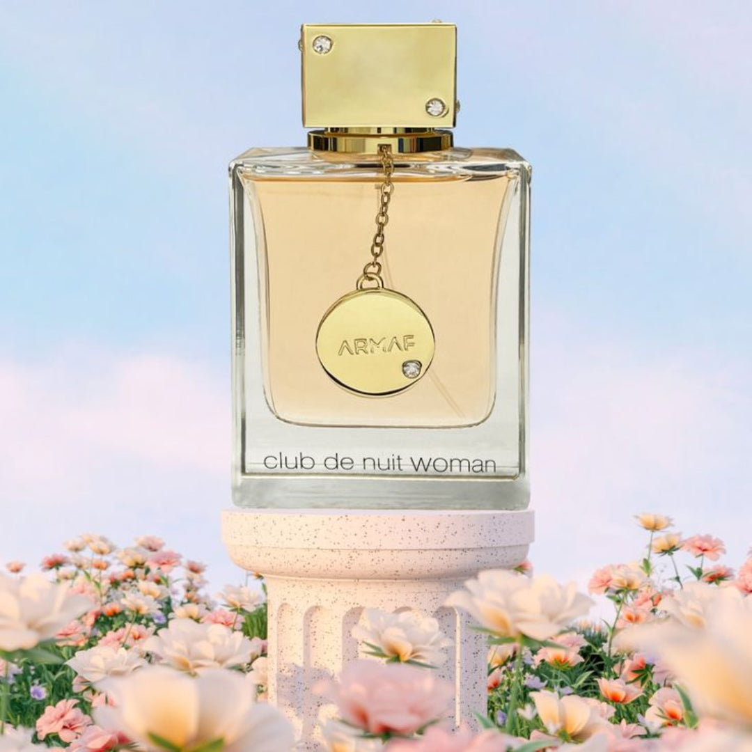 Armaf Club de Nuit Woman perfume bottle with flowers in the background