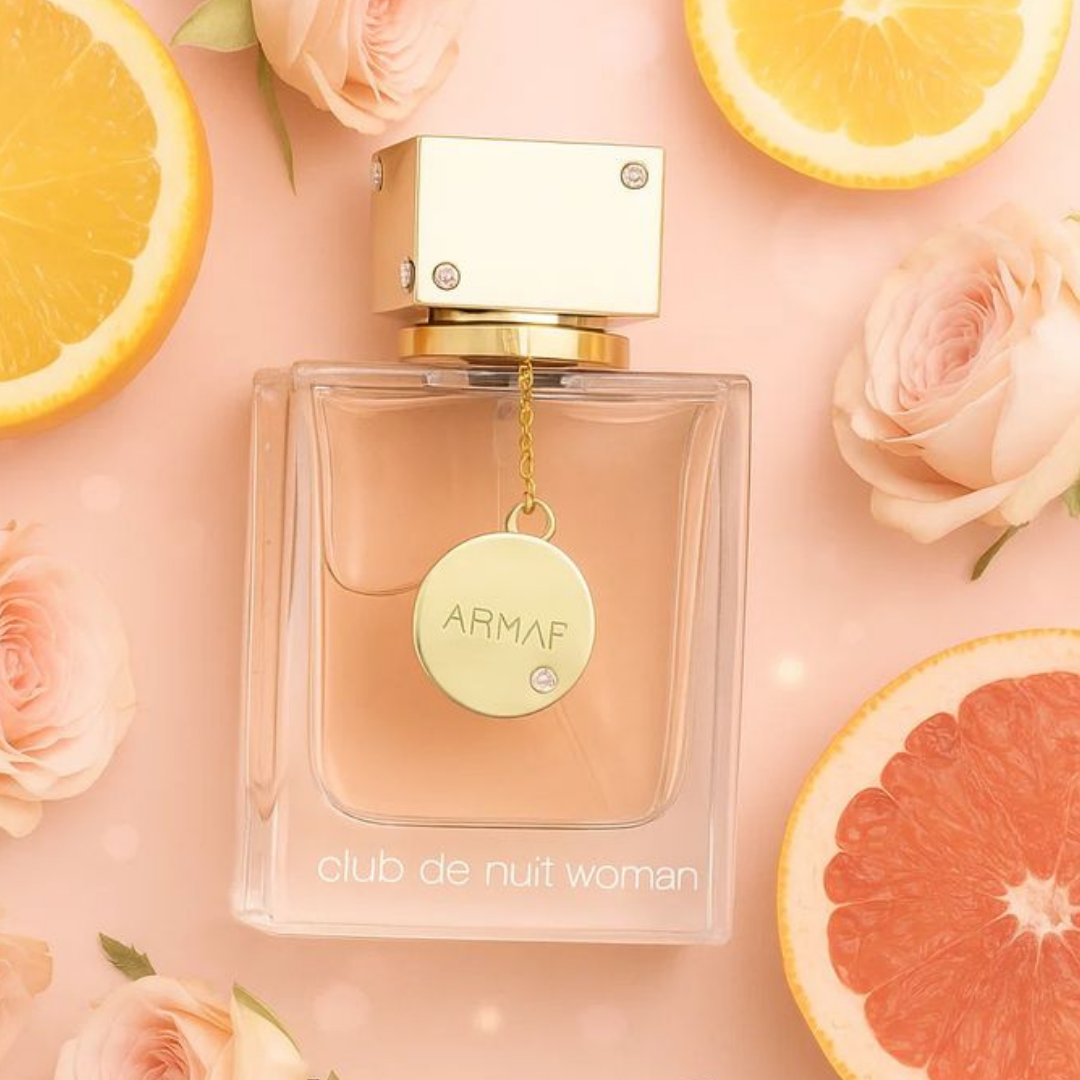 ARMF perfume bottle with flowers and fruit slices on a pink background