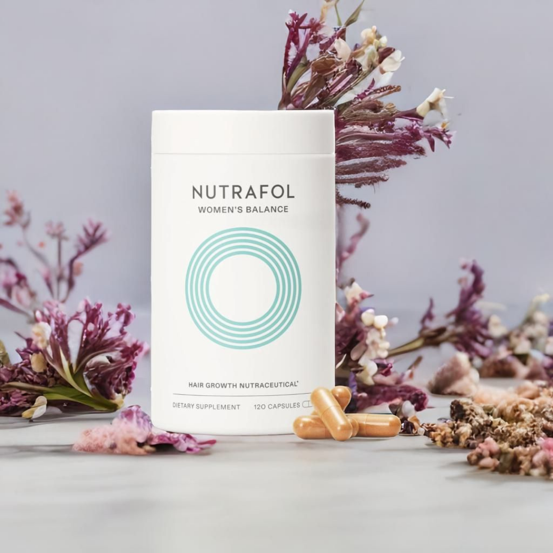 Nutrafol Women's Balance supplement package with capsules on a gray background with flowers.