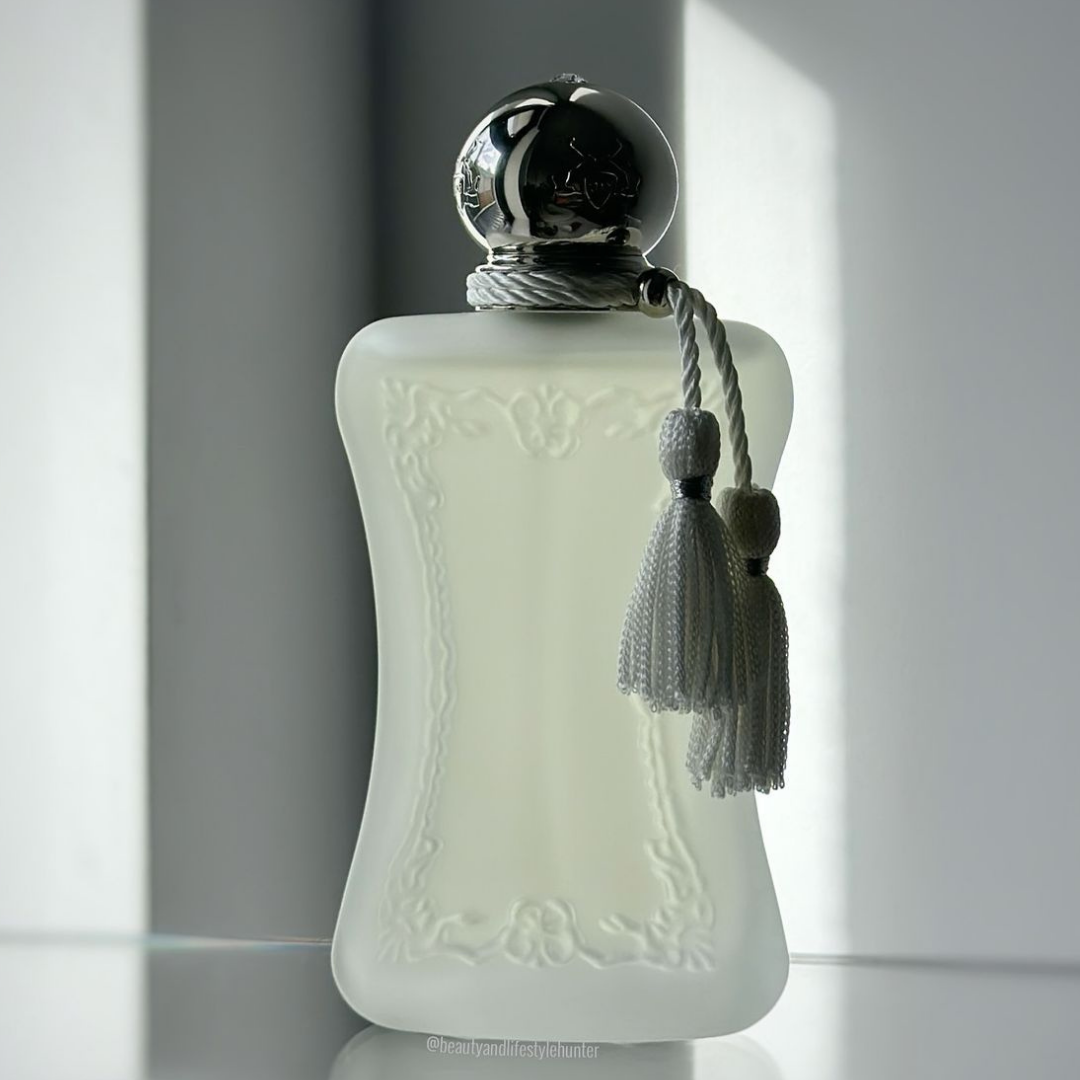 Decorative bottle with a silver cap and gray tassel on a light background